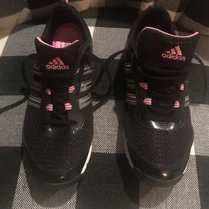 Black adidas sneakers with pink accents
